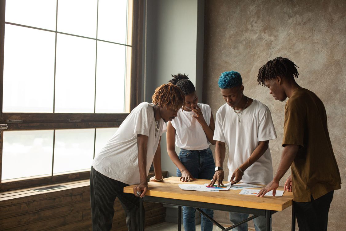 Colleagues discussing a project around a table